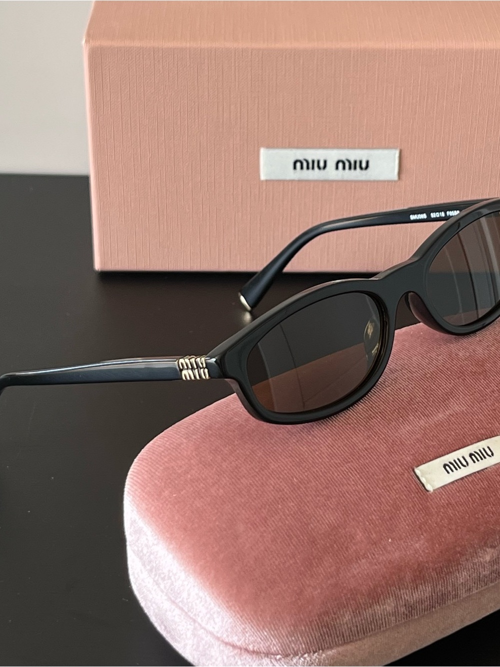 Miu Miu SMU06S Black Oval Sunglasses with Brown Lenses